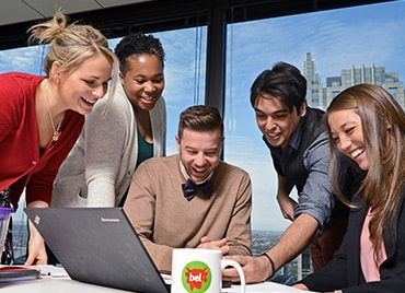 Bel employees in office w/ computer